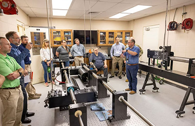 Dr. Robert Moser, ERDC's Senior Scientific Technical Manager, discusses advanced materials and experimental testing capabilities with USACE District personnel.
